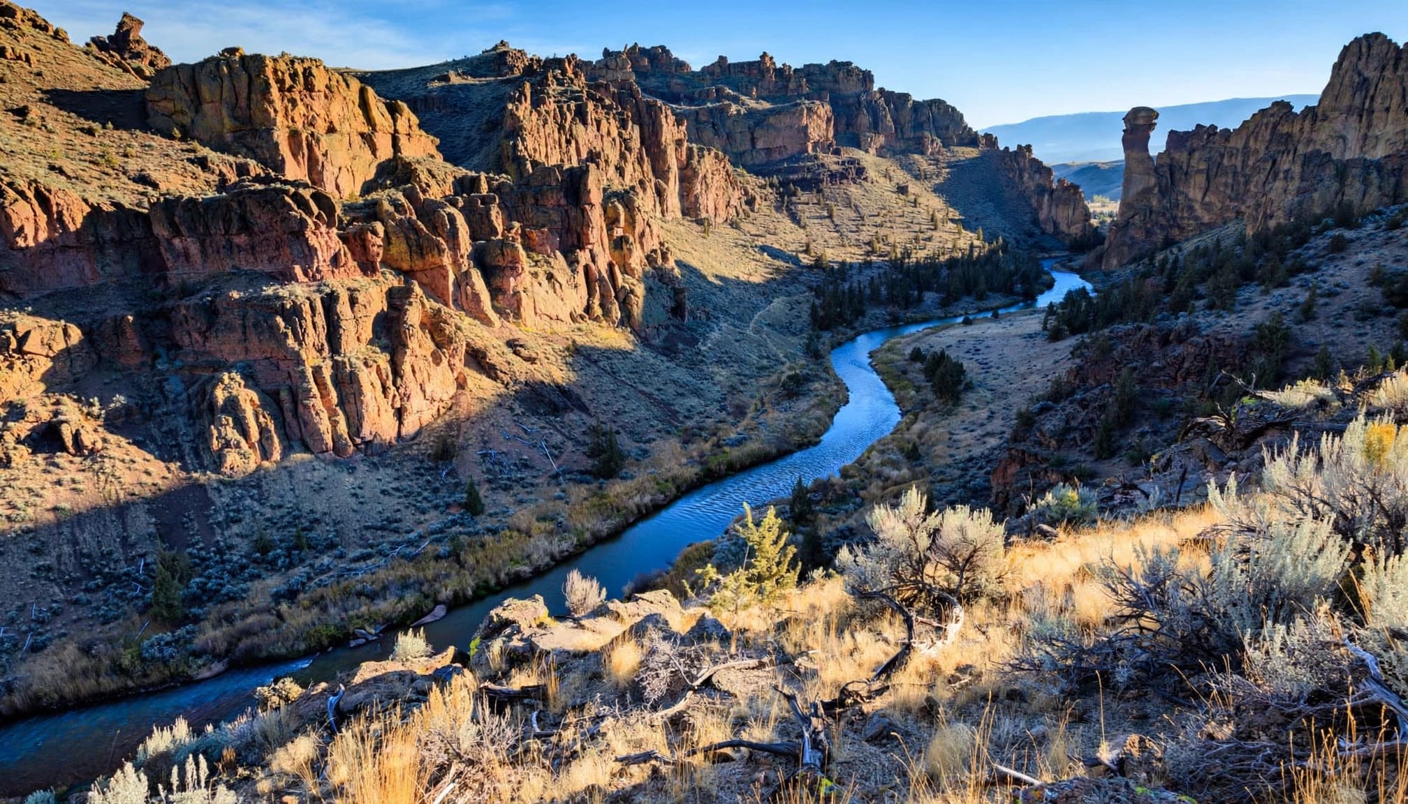 The Crooked River winds below Smith Rock cliffs with Monkey Face in the distance.